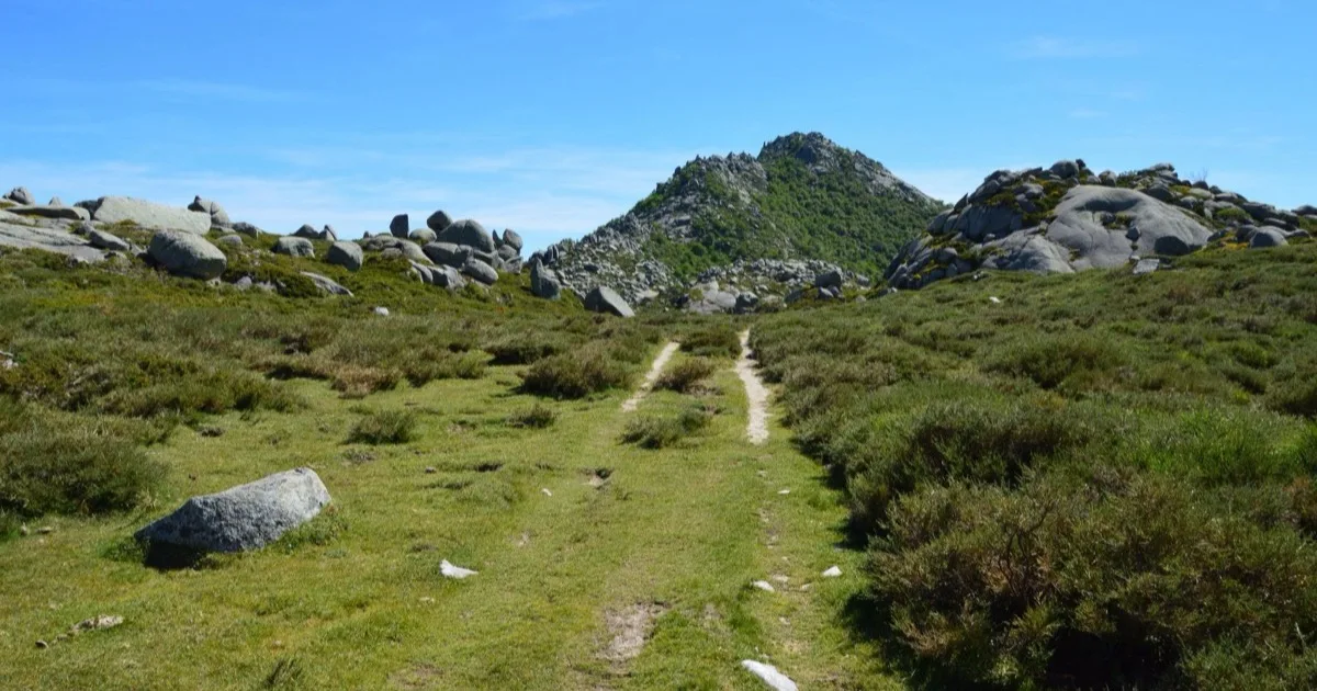 Hiking the GR20 in Corsica: rocky mountain path between granite boulders